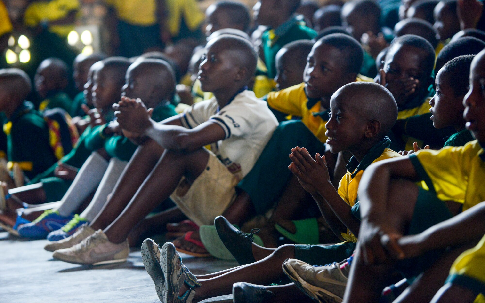 Students of the Home de la vierge des Pauvres Gatagara/Nyanza listen to music played by the U.S. Air Forces in Europe Band Touch N' Go in the Nyanza District, Rwanda, March 5, 2019. The USAFE Band played for HVP Nyanza as part of an outreach event. The band uses these events to further increase cultural ties and enhance the people-to-people relationship between the United States and its partners such as Rwanda. (U.S. Air Forces photo by Tech. Sgt. Timothy Moore)