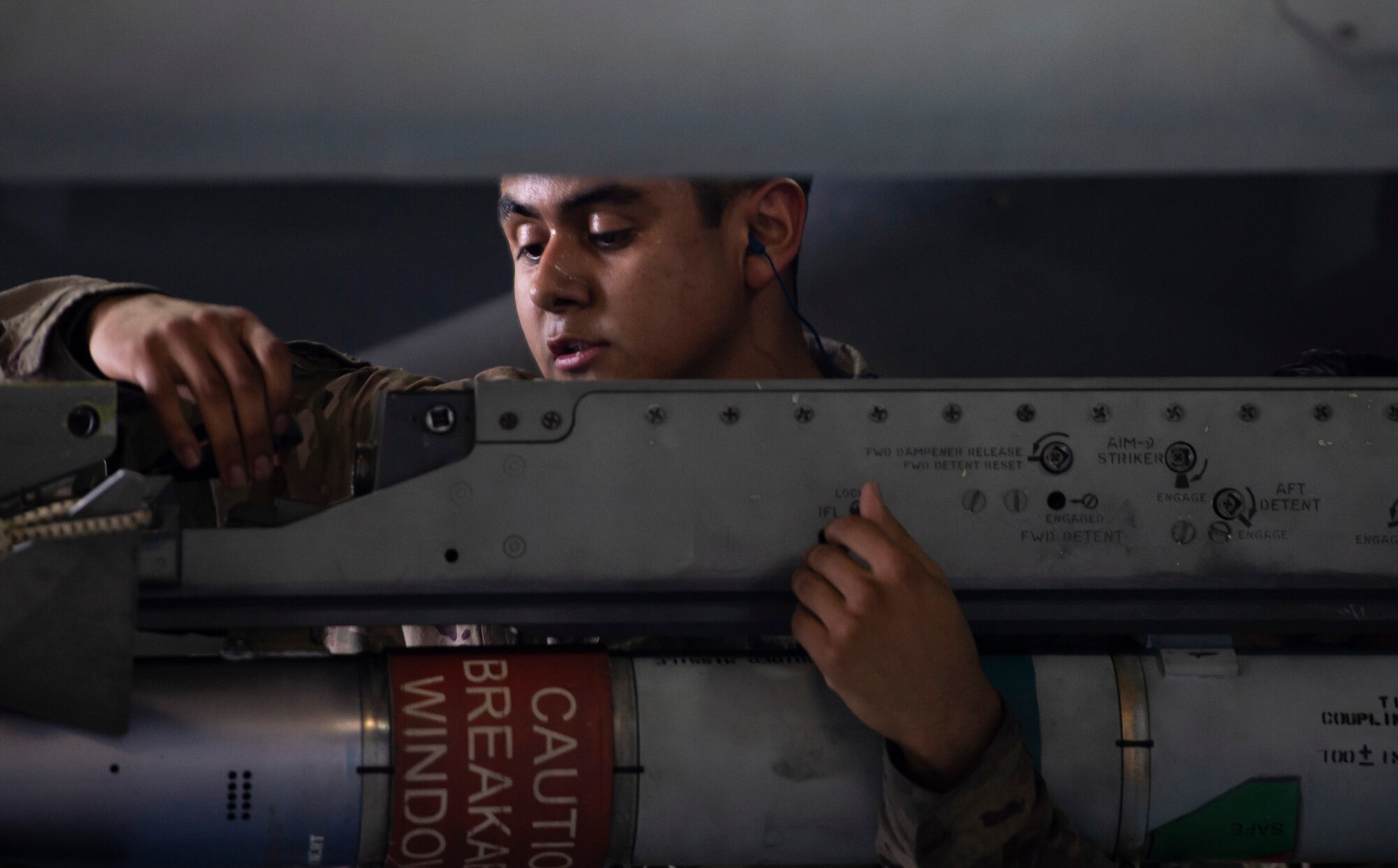 U.S. Air Force Airman 1st Class Daniel Nunez, 20th Aircraft Maintenance Squadron, 77th Aircraft Maintenance Unit load crew member, secures an AIM-9X Sidewinder on an F-16 Fighting Falcon during a Load Crew of the Year competition at Shaw Air Force Base, S.C., March 1, 2019.