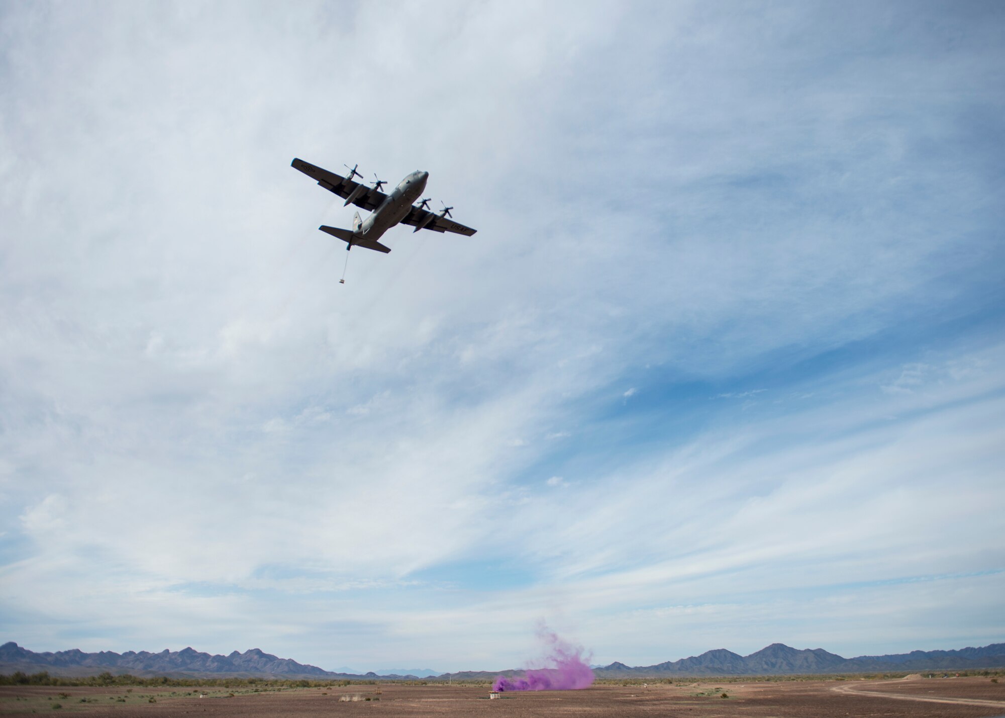 A C-130 Hercules from the 133rd Airlift Wing airdrops a Containerized Delivery System (CDS) over the Yuma Proving Grounds, Ariz. Feb. 26, 2019.