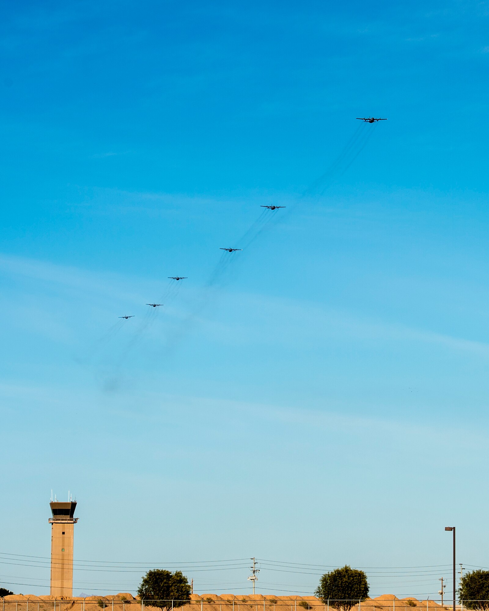 Six C-130 Hercules prepare to land after an airdrop mission in Yuma, Ariz. Feb. 28, 2019.