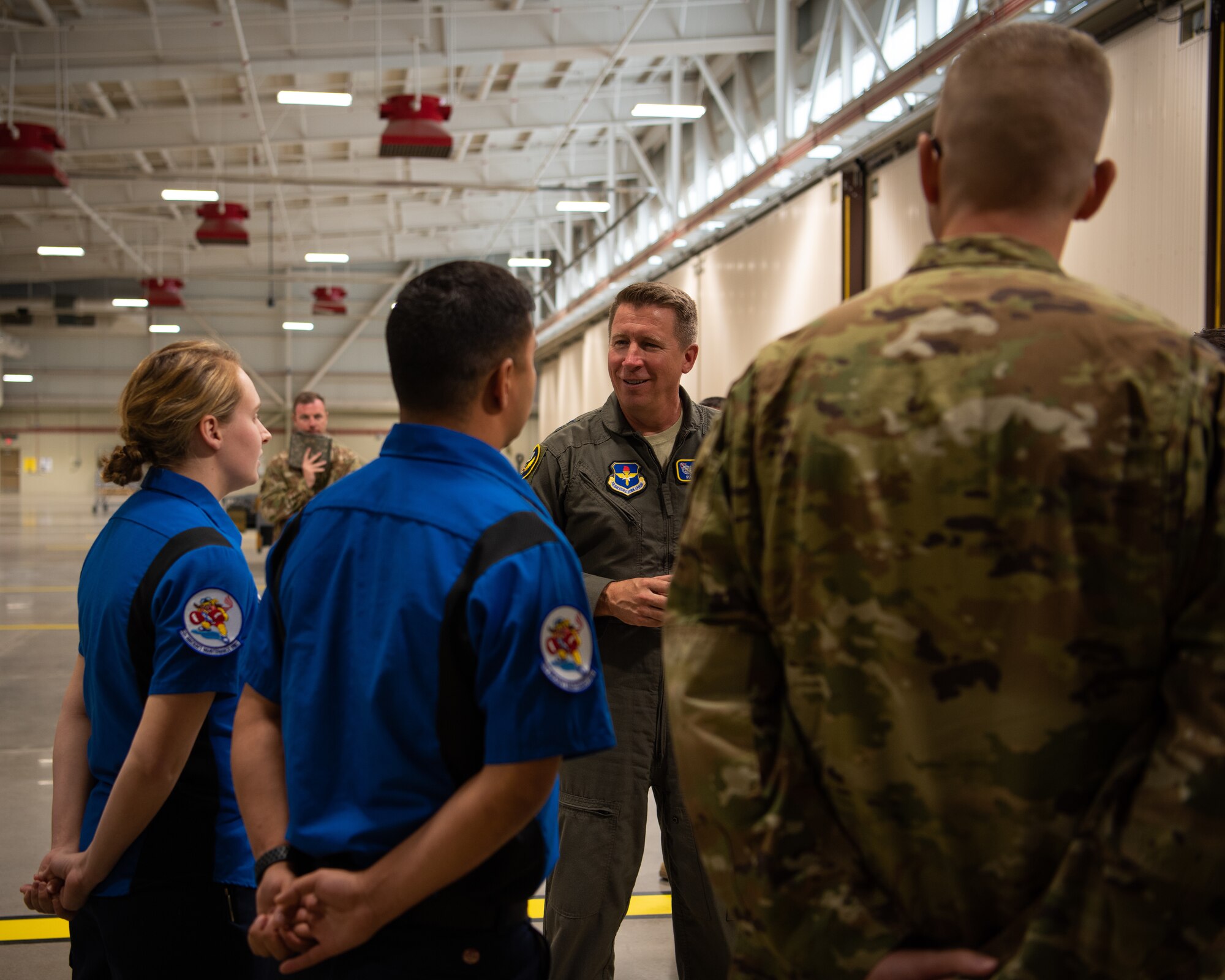 Maj. Gen. Patrick Doherty, 19th Air Force commander, speaks with two Airmen involved with the Lightning Integrate Technician program March 4, 2019 at Luke Air Force Base, Ariz.