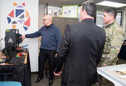 Brian Marchitello (left) Sean Harrington from the Air Education and Training Command Innovation Advancement Division, highlight the 3D printing capabilities of the "Fire Pit" to Col. Jason Lamb (right), AETC's Director of Intelligence, Analysis, and Innovation, March 5, 2019, at Joint Base San Antonio-Randolph, Texas. The 3D print capability is just one of the tools in the Fire Pit designed to help innovators across the command use technology as part of the effort to see how people can learn more effectively.