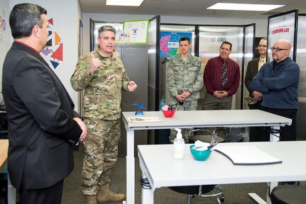 Col. Jason Lamb (second from left), Air Education and Training Command Director of Intelligence, Analysis, and Innovation, speaks to attendees at the grand opening of the command's "Fire Pit" workshop March 5, 2019, at Joint Base San Antonio-Randolph, Texas. Mirrored to the wing level Spark Cell variant, the AETC Fire Pit is the major command’s effort to invigorate innovation and support grassroots initiatives in a collaborative space designed to incubate and accelerate innovation initiatives and build a network with industry, academia, and the Department of Defense to provide rapid solutions to the needs of the warfighter.