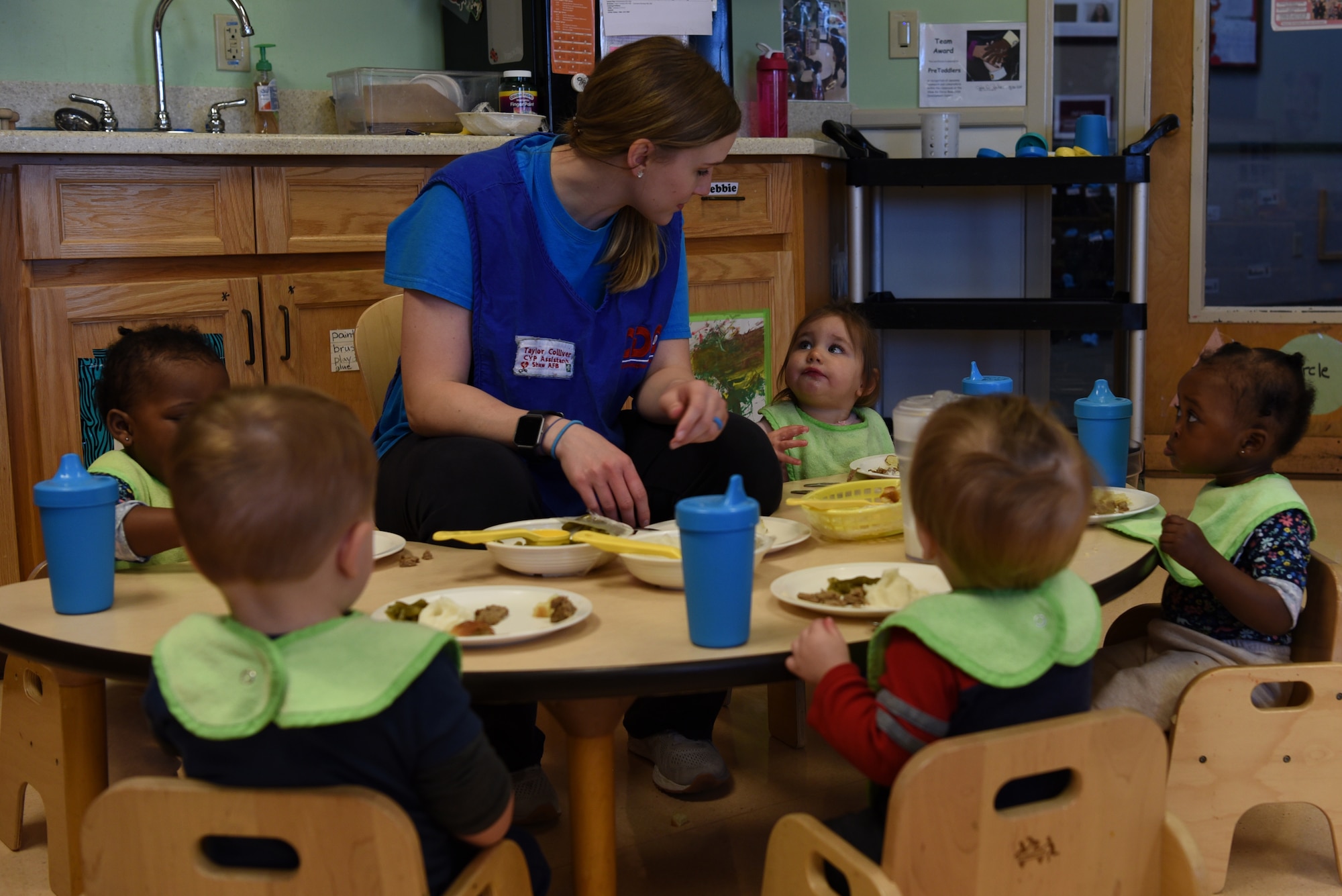 Taylor Colliver, 20th Force Support Squadron Child Development Center (CDC) caregiver, feeds lunch to the children in her care at Shaw Air Force Base, S.C., Feb. 25, 2019.