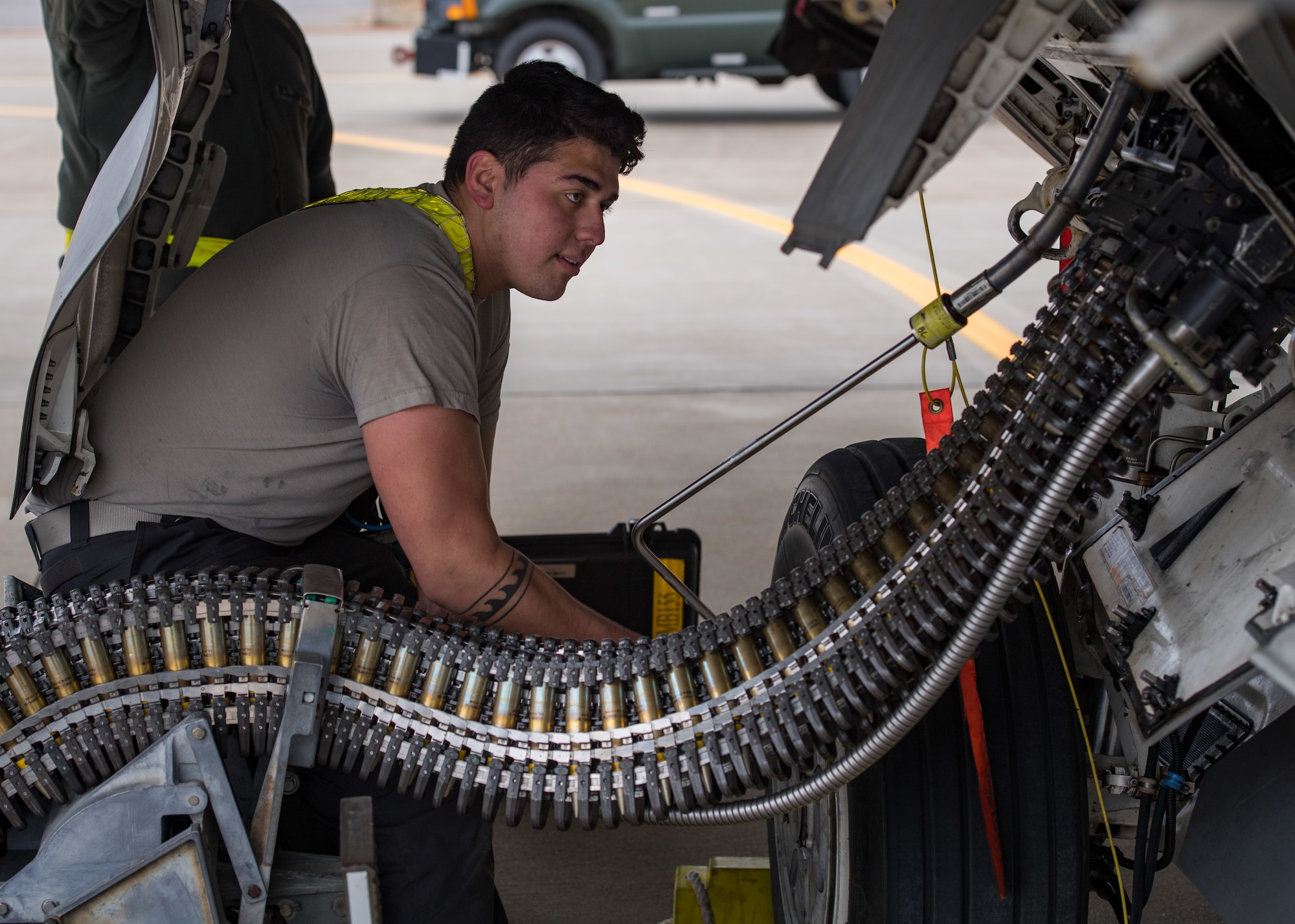 U.S. Air Force Senior Airman Ethan Ornelas, 1st Aircraft Maintenance Squadron weapons load crew member, loads  munitions into an F-22 Raptor during a total force exercise at Joint Base Langley-Eustis, Virginia, Feb. 28, 2019.