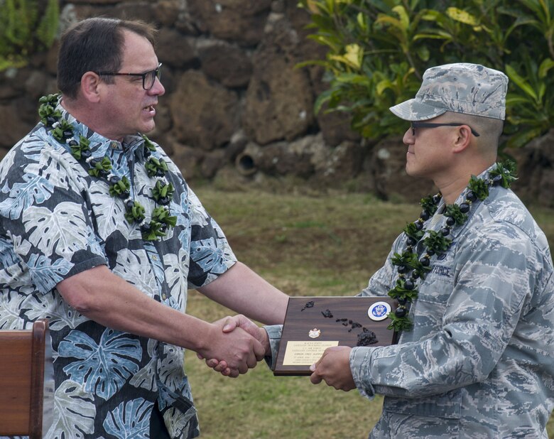 Jason Hughes, 21st Space Operations Squadron, Detachment 3 site manager, presents a plaque to Maj. Edmond Chan, 21st SOPS, Det. 3 commander, for excellence in command during the detachment’s 60th anniversary ceremony at Kaena Point Tracking Station, Hawaii, Feb. 28, 2019. Det. 3 systems were installed as part of a five-station network launched Feb. 28, 1959. Today, Det. 3 is one of eight worldwide antennas in the Air Force Satellite Control Network that provides telemetry, tracking and command functions for Department of Defense satellites, including weather, early warning, navigation, communication and other high-priority space programs. (U.S. Air Force photo by Staff Sgt. Jack Sanders)