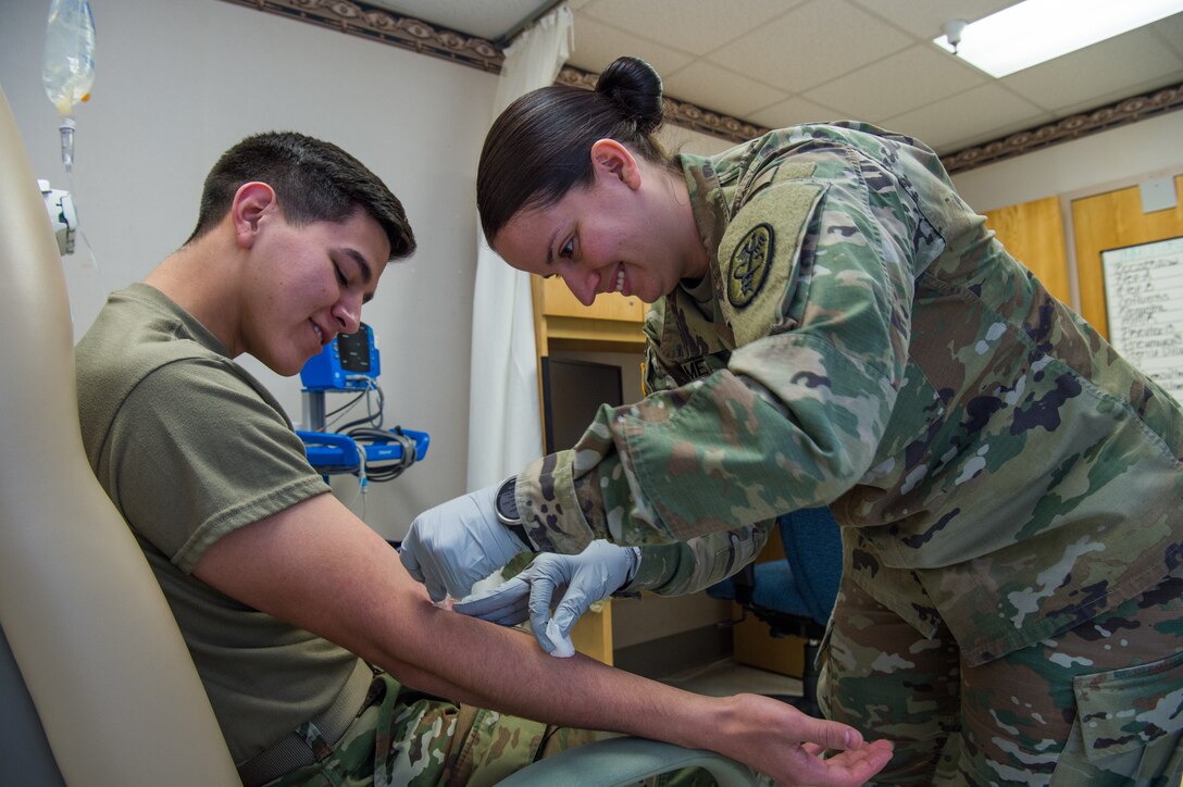 U.S. Army Sgt. Valeria Melton, McDonald Army Health Center NCO in charge of internal medicine, trains Spc. Heaith Howe, McDonald Army Health Center radiology specialist, on how to do an IV at Joint Base Langley-Eustis, Virginia, Feb. 5, 2019.