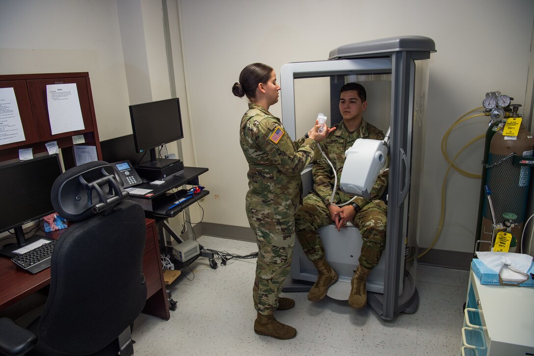 U.S. Army Sgt. Valeria Melton, McDonald Army Health Center NCO in charge of internal medicine, trains Spc. Heaith Howe, McDonald Army Health Center radiology specialist, on how a Pulmonary Function Test machine works at Joint Base Langley-Eustis, Virginia, Feb. 5, 2019.