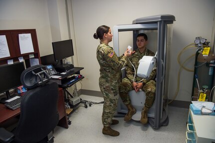 U.S. Army Sgt. Valeria Melton, McDonald Army Health Center NCO in charge of internal medicine, trains Spc. Heaith Howe, McDonald Army Health Center radiology specialist, on how a Pulmonary Function Test machine works at Joint Base Langley-Eustis, Virginia, Feb. 5, 2019.