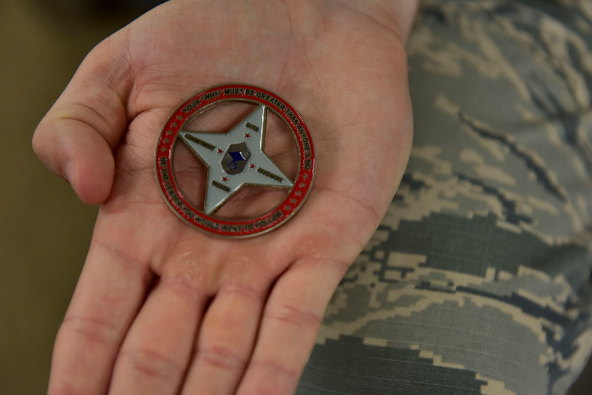 U.S. Air Force Staff Sgt. Brandon Nickell, 8th Intelligence Squadron intelligence analyst, holds a coin he received for assisting a wingman experiencing a medical emergency at Joint Base Pearl Harbor-Hickam, Hawaii, Feb. 25, 2019. Nickell’s actions saved the life of Chief Master Sgt. James Worrell, 56th Air Communications Squadron superintendent. (U.S. Air Force photo by Staff Sgt. Eboni Prince)