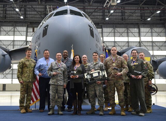 Annual award winners stand with their leadership after being recognized at the 437th Airlift Wing Annual Awards Ceremony March 1, 2019, at Joint Base Charleston, S.C.