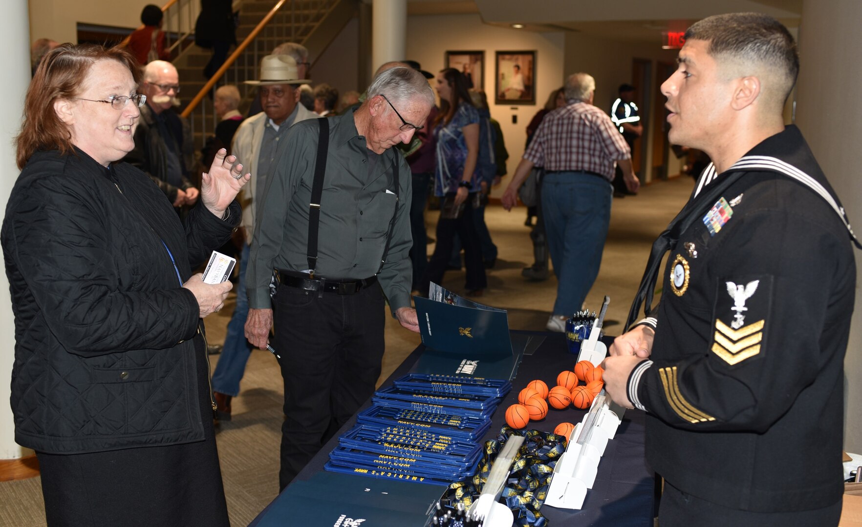 Nina McGrath, founding director of the San Antonio Youth Wind Ensemble, speaks with Petty Officer 1st Class Jose Zouain, assigned to Navy Recruiting Station San Marcos, during the U.S. Navy Band concert held in the Jackson Auditorium on the campus of Texas Lutheran University.  The U.S. Navy Band performed in 10 states during its 23-city, 5,000-mile tour, connecting communities across the nation to the Navy.
