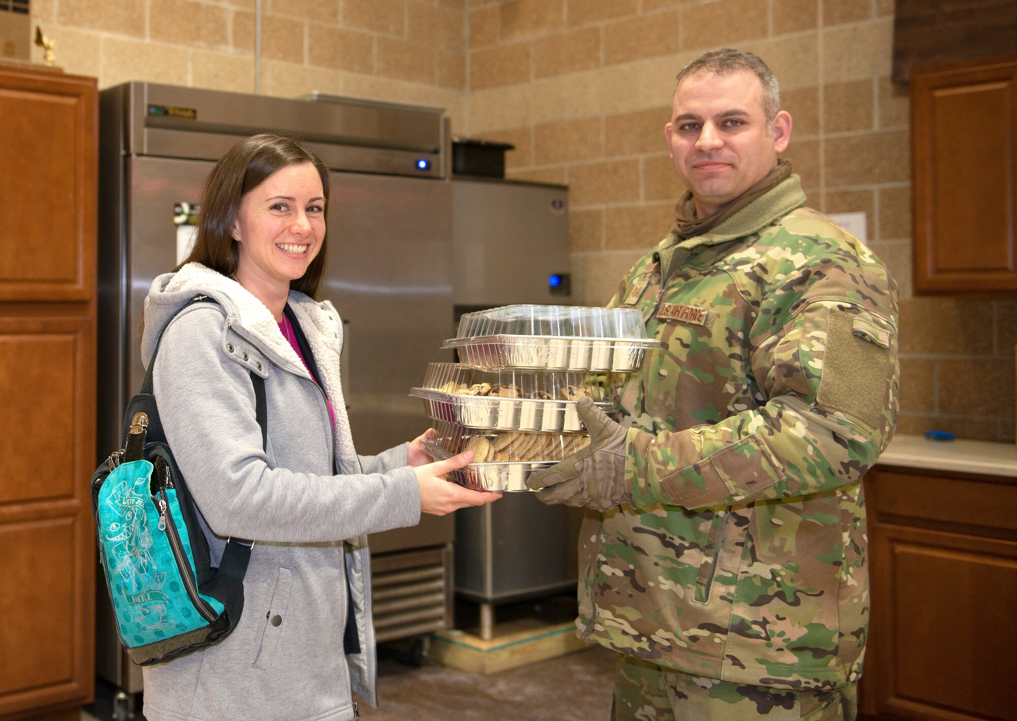 Offutt’s 2019 Military Spouse of the Year, Kasey Potts, wife of Capt. Timothy Potts, delivers homemade cookies Mar. 5, 2019, to Tech. Sgt. Raymond Santiago, 55th Security Forces Squadron, at Offutt Air Force Base, Neb. The cookies were delivered as a “thank you” to the men and women currently manning the gates enduring extreme weather. (U.S. Air Force photo by L. Cunningham)