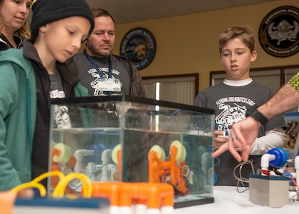 Patronis Elementary School Robotics League Students and Naval Surface Warfare Center Panama City Division (NSWC PCD) Scientist and Lego Robotics League Mentor, Duane Odom, watch a demonstration during NSWC PCD’s inaugural STEMinar event March 6. The STEMinar is held to encourage scientist and engineers to get engaged with the various outreach programs we hold in the local area.