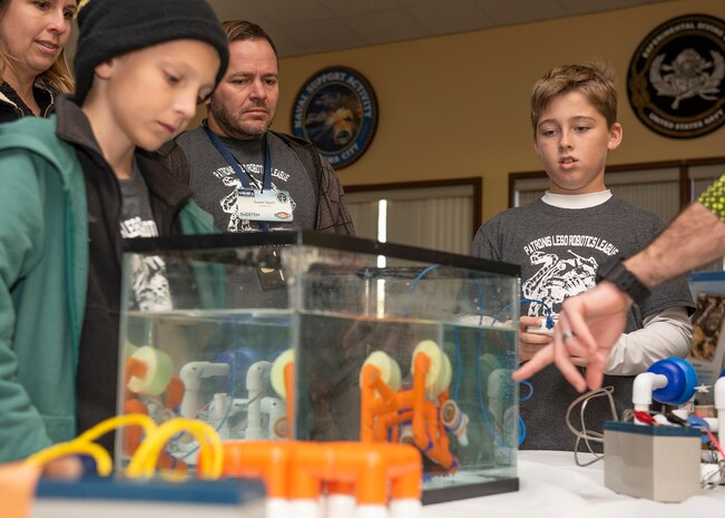 Patronis Elementary School Robotics League Students and Naval Surface Warfare Center Panama City Division (NSWC PCD) Scientist and Lego Robotics League Mentor, Duane Odom, watch a demonstration during NSWC PCD’s inaugural STEMinar event March 6. The STEMinar is held to encourage scientist and engineers to get engaged with the various outreach programs we hold in the local area.