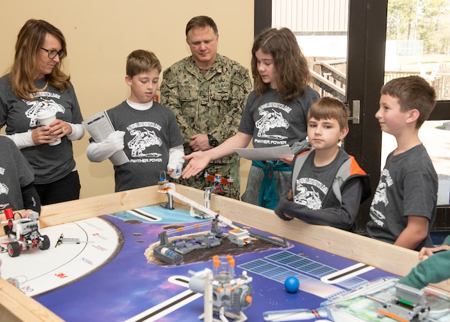 Patronis Elementary School Robotics League Students and Naval Surface Warfare Center Panama City Division Commanding Officer Capt. Aaron Peters, watch a demonstration during the inaugural STEMinar event March 6. Through STEM outreach, there is an opportunity to prepare the next generation of scientists and engineers so we can make sure that we are the undisputed technical expert throughout the littoral battlespace.