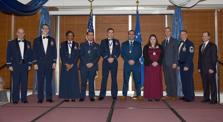 Winners are recognized during the AEDC Annual Awards banquet Feb. 8 in the Arnold Lakeside Center at Arnold Air Force Base. Pictured from left are Col. William Brandt Jr., keynote speaker for the banquet; AEDC Commander Col. Scott Cain; TSgt. Alexisa Humphrey; Airman First Class Rodrigo Noriega; Capt. Adrian Catarius; Adam Foret; Stacey Lamb; Elijah Minter; AEDC Superintendent Chief Master Sgt. Robert Heckman; and AEDC Technical Director Ed Tucker. (U.S. Air Force photo by Bradley Hicks)