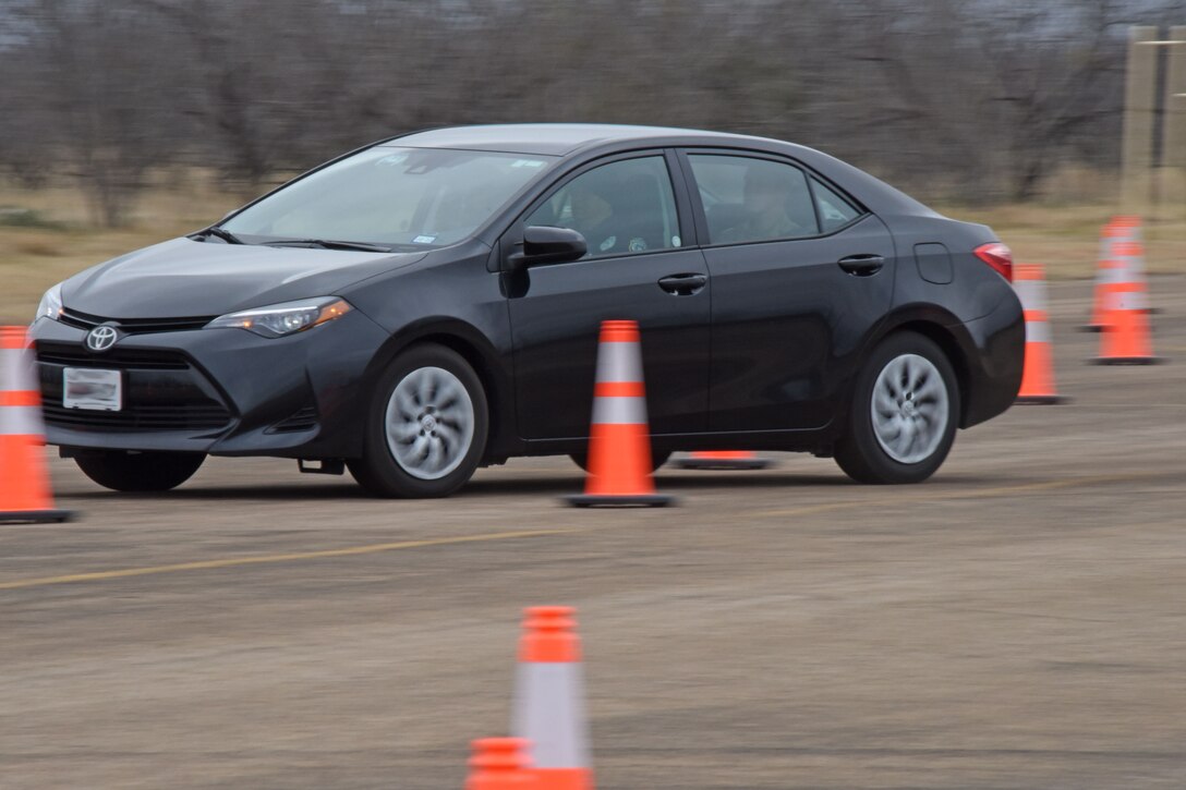 Members from the 17th Security Forces Squadron and instructors from The Shooting Institute drive through a tactical driving course during training at Goodfellow Air Force Base, Texas, Feb. 26, 2019. The course involved advancing techniques in driving, high risk traffic stops and handling situations with active shooters. (U.S. Air Force photo by Senior Airman Seraiah Hines/Released)
