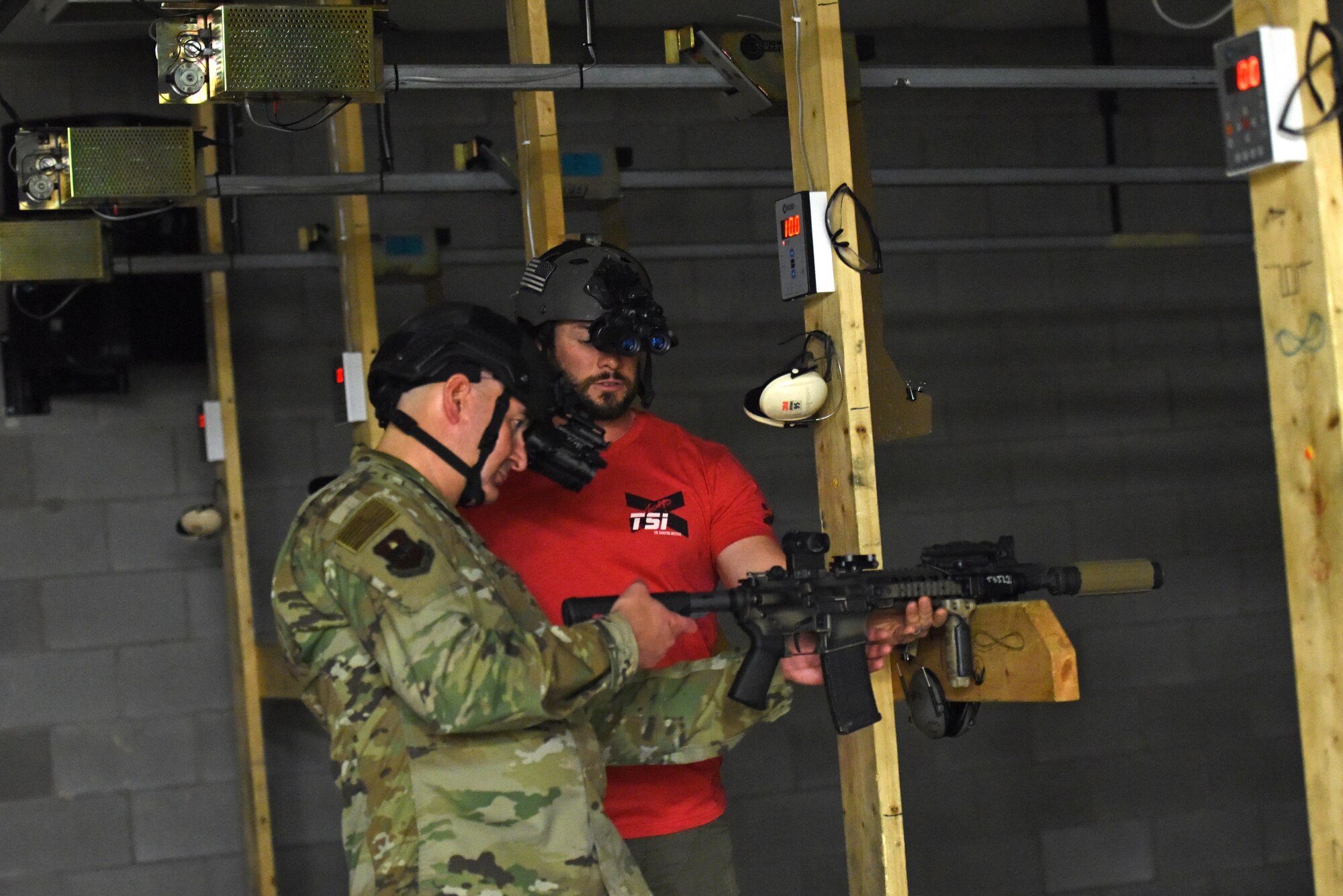 U.S. Air Force Col. Robert Ramirez, 17th Training Wing vice commander, receives information about the nighttime capabilities of a suppressed rifle with a laser site used in combination with night vision goggles, from The Shooting Institute Founder and CEO, Jared Hudson, at the shooting range on Goodfellow Air Force Base, Texas, March 1, 2019. Leadership from Goodfellow were invited to participate in a demonstration at the end of the tactical driving course to understand what members from the 17th Security Forces Squadron had learned throughout the course. (U.S. Air Force photo by Senior Airman Seraiah Hines/Released)