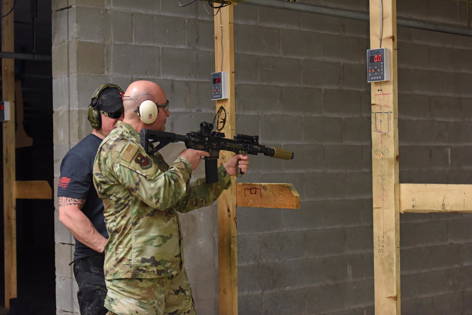 The Shooting Institute Instructor and Director of Marketing, Micheal Fehsal, reviews U.S. Air Force Col. Robert Ramirez’s, 17th Training Wing vice commander, technique for shooting a suppressed rifle during a weapons demonstration at the shooting range on Goodfellow Air Force Base, Texas, March 1, 2019. Leadership from Goodfellow were invited to watch and participate in a demonstration of the different weapons that the 17th Security Forces Squadron worked with during the tactical driving course. (U.S. Air Force photo by Senior Airman Seraiah Hines/Released)