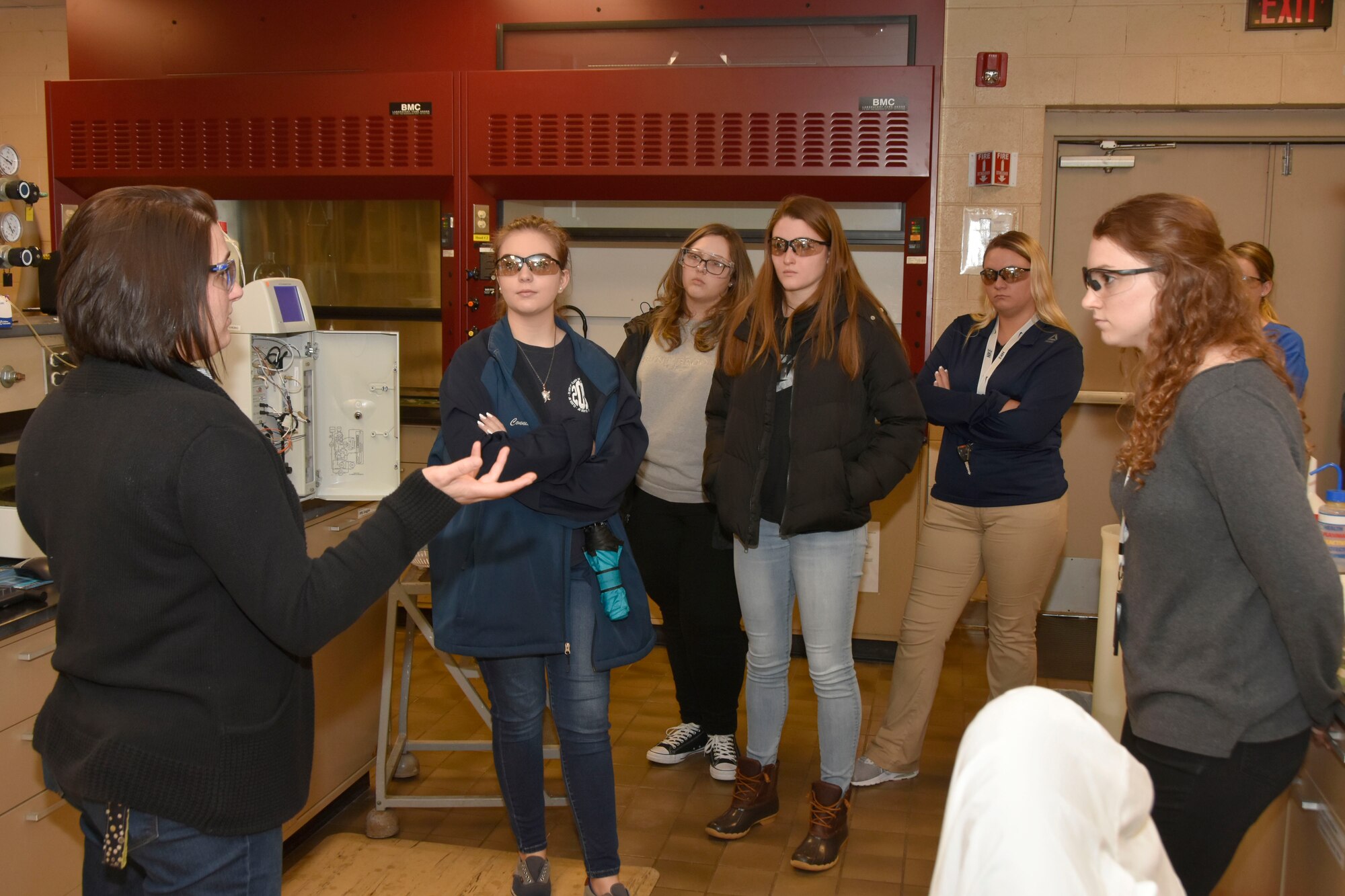 Lena Elenchin, a chemical analyst at Arnold Air Force Base, left, and Mary Forde, an engineer and scientist at Arnold, right, discuss their work in the Arnold Chemical and Metallurgical Lab with a group of area high schoolers during the Engineer for a Day event. (U.S. Air Force photo by Bradley Hicks)