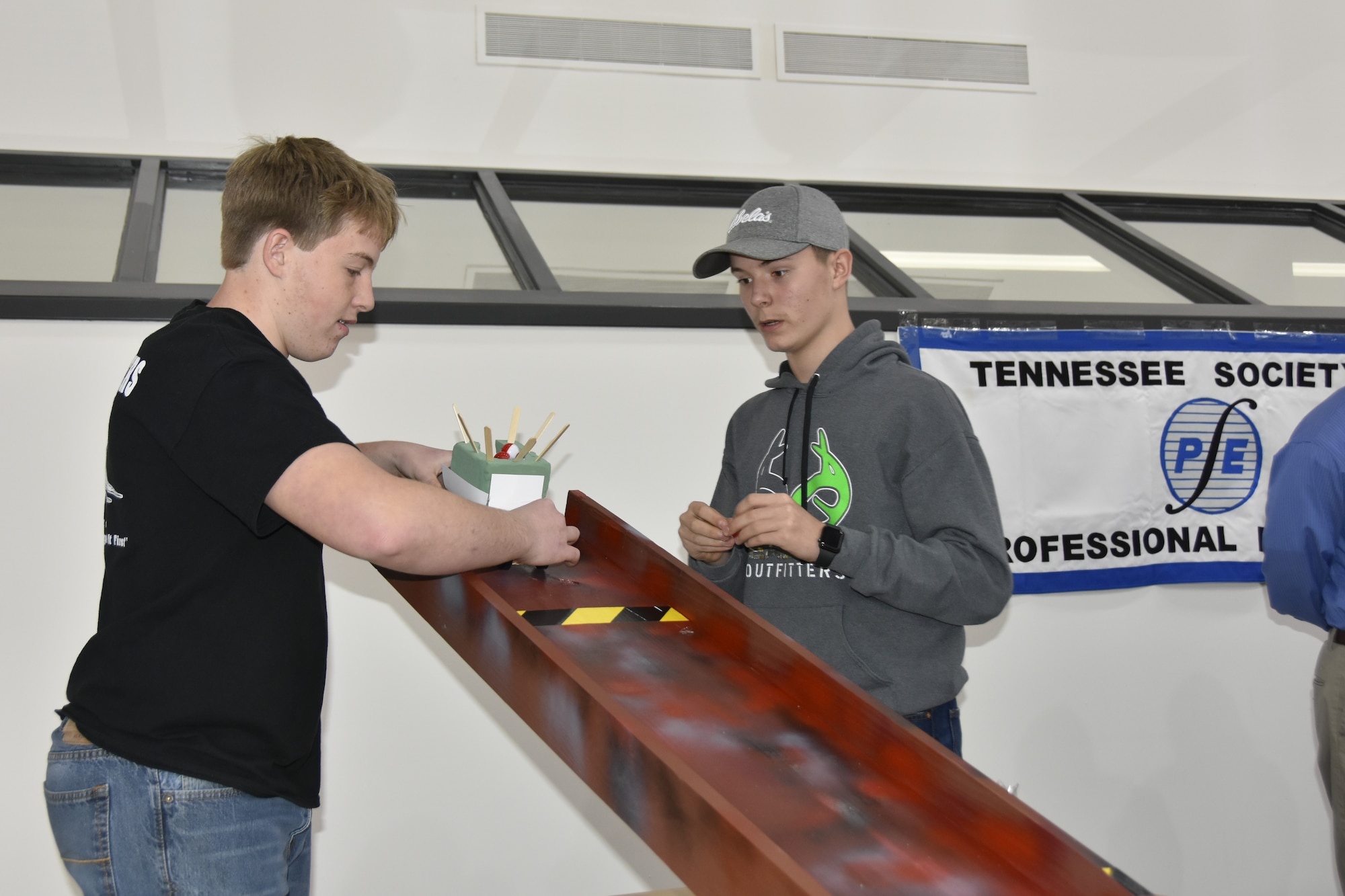 Andrew Barrett and Luke Sweeney from Grundy County High School load their “robot” for a trial run during the Student Design Competition Feb. 19 at the University of Tennessee Space Institute. Barrett and Sweeney placed third in the competition. Nearly 50 students from seven area high schools participated in the event. (U.S. Air Force photo by Bradley Hicks)