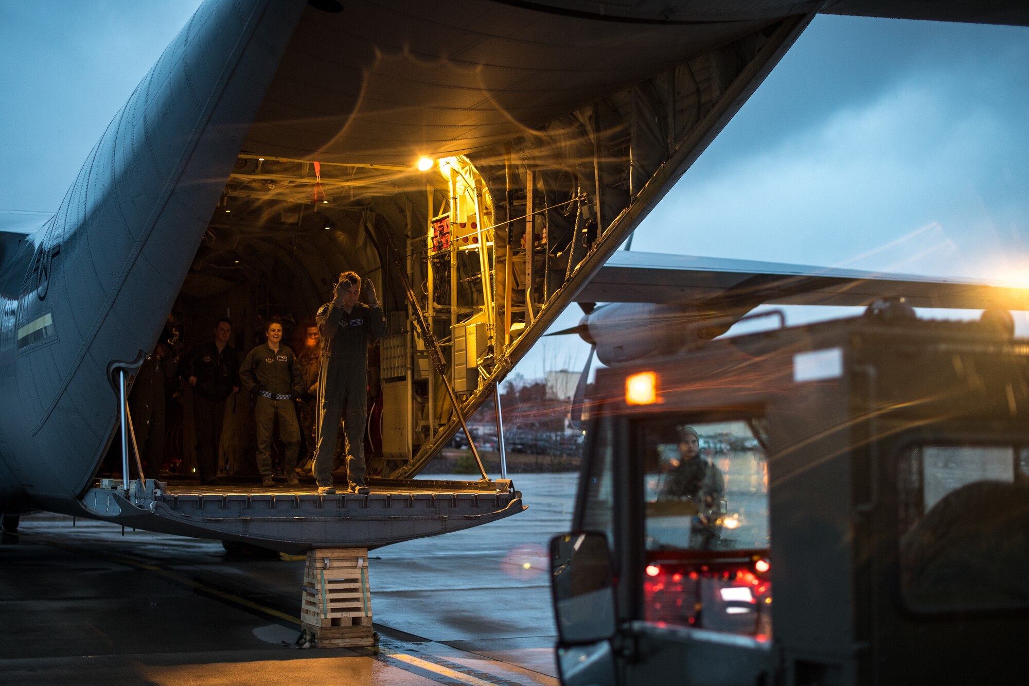 A U.S. Air Force Airman assigned to the 37th Airlift Squadron directs a loader to the ramp of a C-130J Super Hercules on the flightline at Ramstein Air Base, Germany, March 1, 2019. Multiple units from Ramstein worked together to load up a forklift and pallet in the middle of an exercise. (U.S. Air Force photo by Staff Sgt. Devin Boyer)