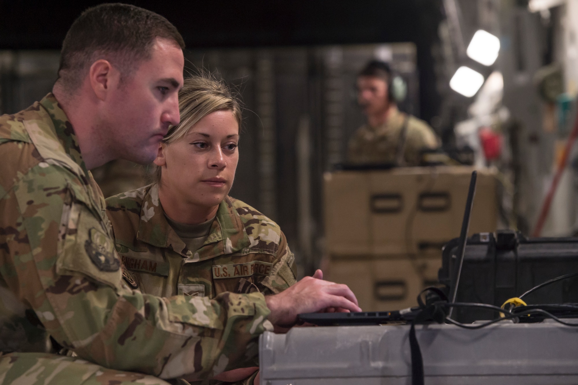 Tech. Sgt. Jason Snell, left, and Staff Sgt. Heather Bingham, both 379th Expeditionary Communications Squadron Viper team operators, set up wireless internet on a C-17 Globemaster III March 5, 2019, at Al Udeid Air Base, Qatar.