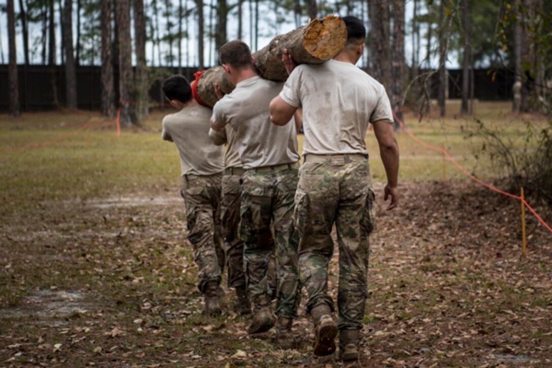 Airmen assigned to the 822d Base Defense Squadron carry a log during Scorpion Stakes, Feb. 20, 2019, at Moody Air Force Base, Ga. The two-day competition includes 18 stations such as a ruck, litter carry, simulated hostage rescue and vehicle search. The event has 18 four-Airman teams who are competing for 1st, 2nd and 3rd place by getting the highest score at the 18 different stations. Scorpion Stakes challenges Airmen on their career training and knowledge while having to physically and mentally overcoming obstacles. (U.S. Air Force photo by Airman 1st Class Taryn Butler)