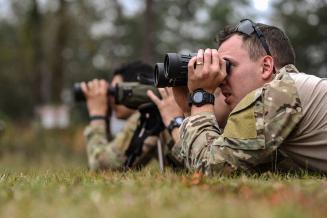 Airmen assigned to the 822d Base Defense Squadron search for targets during Scorpion Stakes, Feb. 20, 2019, at Moody Air Force Base, Ga. The Airmen were given spotting scopes and binoculars to detect targets within a set boundary. The two-day competition includes 18 stations such as a ruck, litter carry, simulated hostage rescue and vehicle search. The event has 18 four-Airman teams who are competing for 1st, 2nd and 3rd place by getting the highest score at the 18 different stations. (U.S. Air Force photo by Airman 1st Class Taryn Butler)