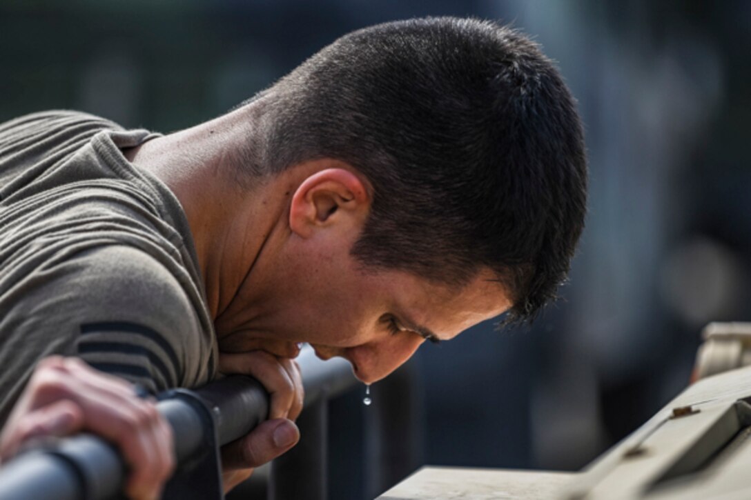 Senior Airman Jonathan Vega, 822d Base Defense Squadron MWD handler, pushes a Humvee during Scorpion Stakes, Feb. 20, 2019, at Moody Air Force Base, Ga. The competition includes 18 stations such as a ruck, litter carry, simulated hostage rescue, vehicle search. Scorpion Stakes takes all the day-to-day fundamental skills and job knowledge and challenges Airmen on their career training and knowledge while having to physically and mentally overcoming obstacles. (U.S. Air Force photo by Airman 1st Class Taryn Butler)