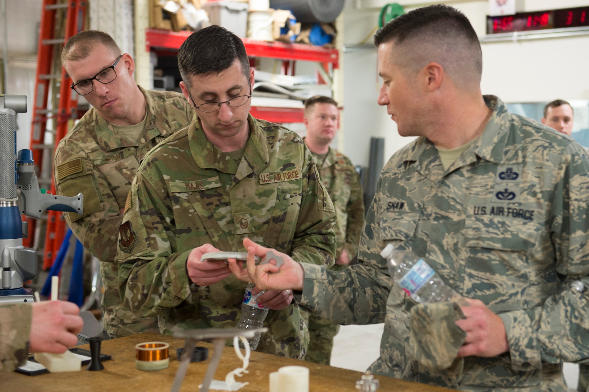 U.S. Air Force Master Sgt. Nathan Shaw (right), superintendent of the Air Force Technical Applications Center's Innovation Lab, shows Air Force Spark Tank winner Master Sgt. Jonathan Maas a project he's working on during a visit to the nuclear treaty monitoring center at Patrick Air Force Base, Florida, March 1, 2019. Looking over Mass' shoulder is Spark Tank finalist Staff Sgt. Travis W. Alton. (U.S. Air Force photo by Matthew S. Jurgens)