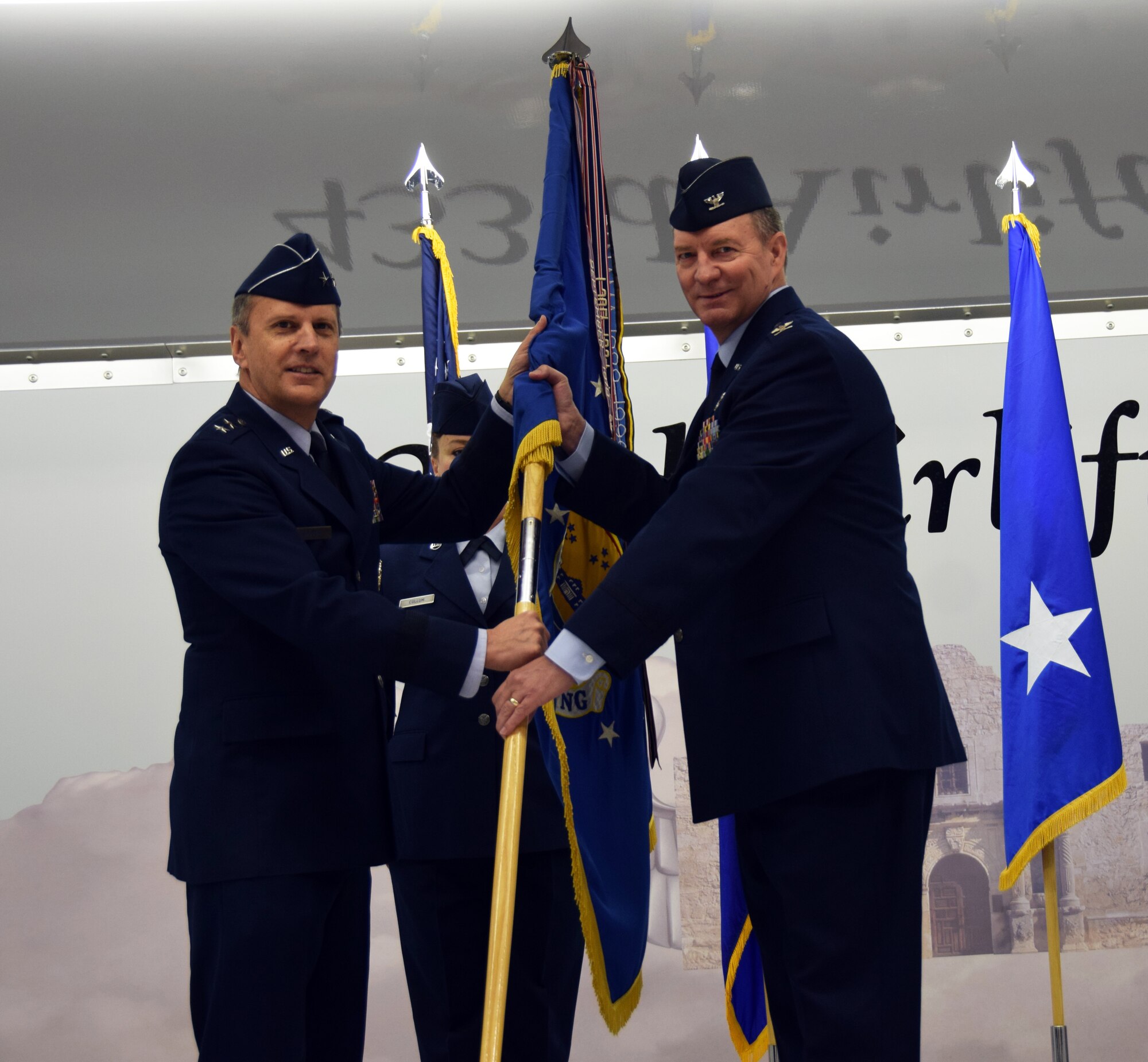 Maj. Gen. Randall A. Ogden, 4th Air Force commander, presents the wing guidon to Col. Terry W. McClain, 433rd Airlift Wing commander, at the 433rd AW change of command ceremony March 3, 2019 at Joint Base San Antonio-Lackland, Texas.