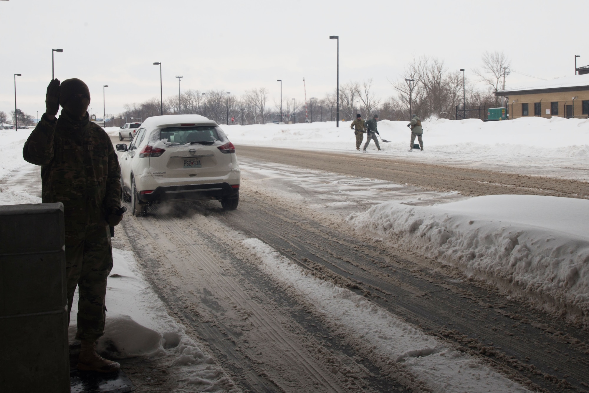 Members of the 55th Security Forces Squadron shovel snow March 7, 2019, on Offutt Air Force Base. The snow was removed in order to open additional lanes of traffic at the U.S. Strategic Command gate. (U.S. Air Force photo by Tech. Sgt. Rachelle Blake)