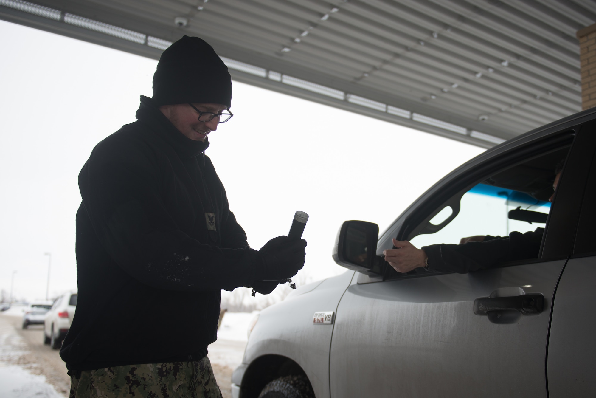 Master of Arms 2nd Class Christopher Henzerling, 55th Security Force Squadron, checks an I.D. at the U.S. Strategic Command gate March 7, 2019, on Offutt Air Force Base. As a gate guard, he is required to perform his duties in austere environments. (U.S. Air Force photo by Tech. Sgt. Rachelle Blake)
