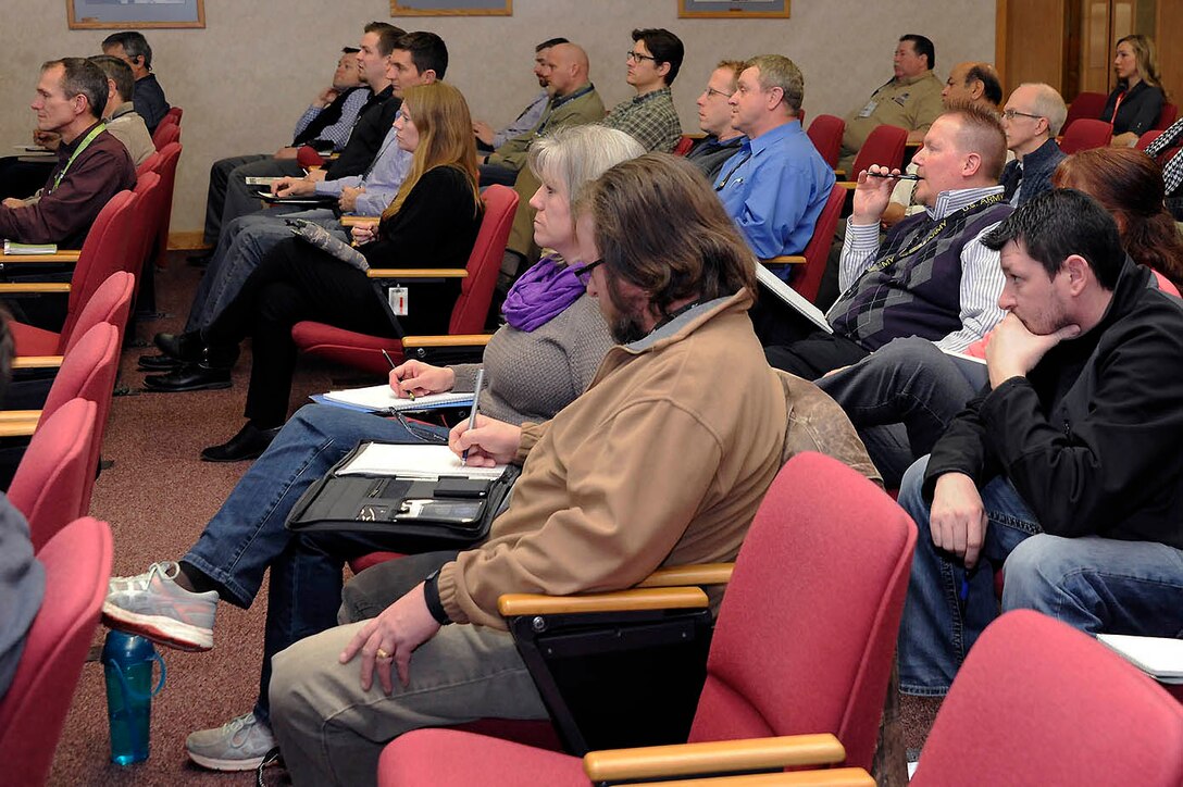 Active duty, veterans and spouses alike listen to how they can become beekeepers.