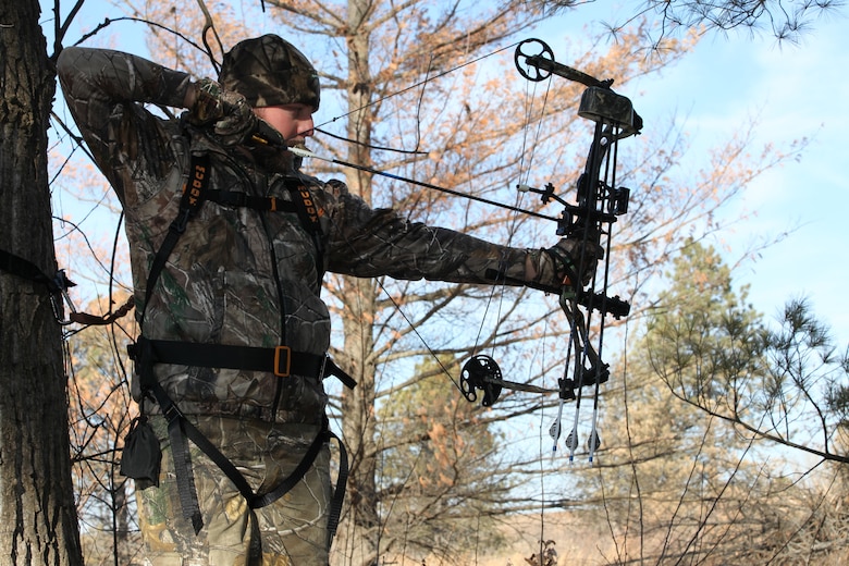 Bow hunter in deer stand.