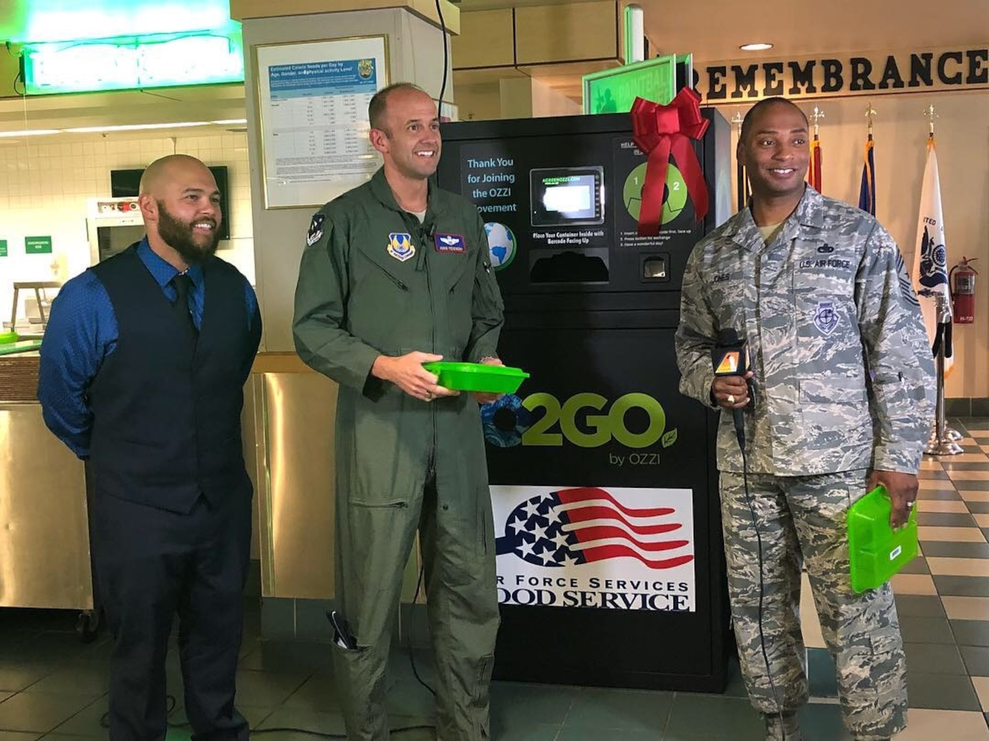 From left: David Behrendt, 412th Force Support Squadron; Brig. Gen. E. John Teichert, 412th Test Wing commander; and Chief Master Sgt. Roosevelt Jones, former 412th TW command chief; discuss the new reusable food containers at the Joshua Tree Dining Facility last year. (Courtesy photo)