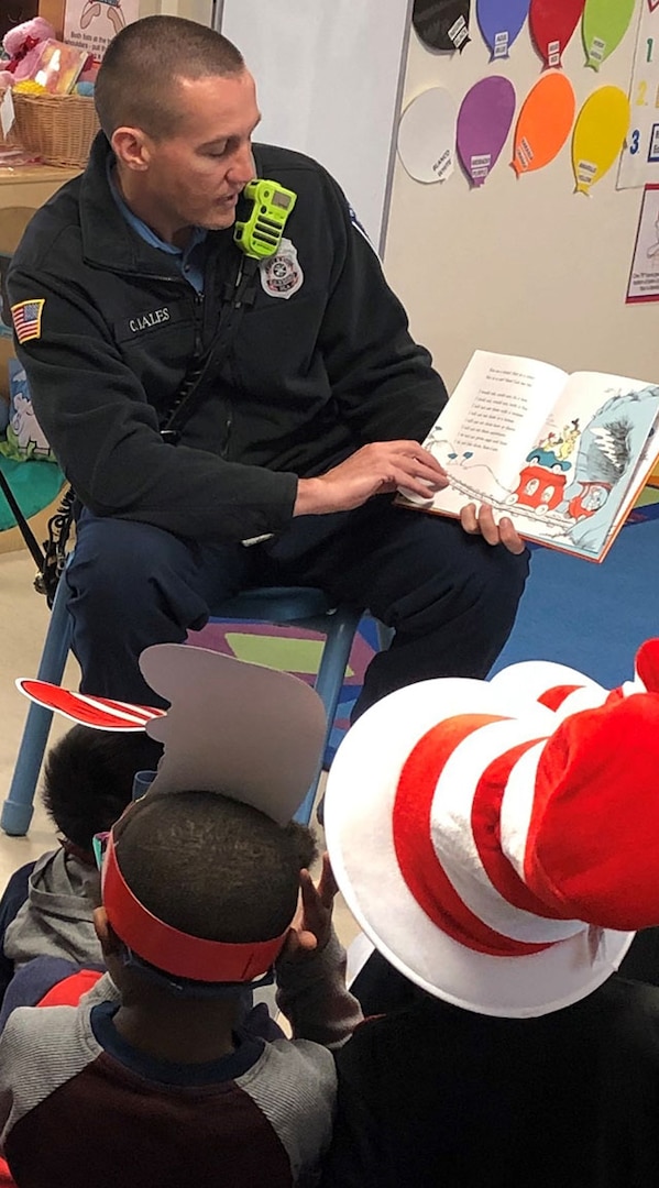 firefighter read to children on Dr. Seuss Day