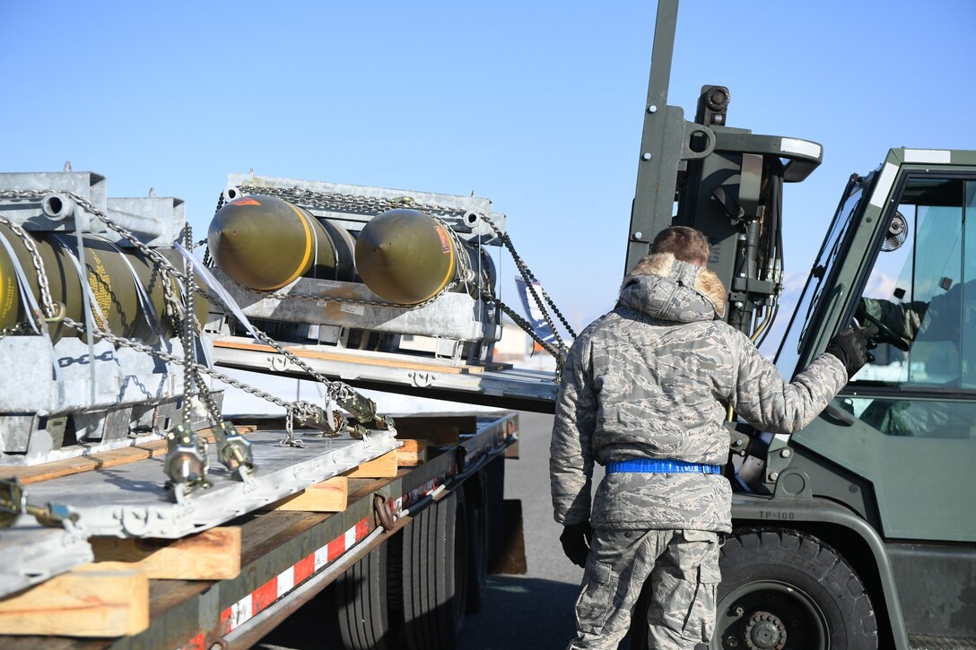 Airman 1st Class Jared Massey, 649th Munitions Squadron, directs the transfer of BLU-109 Penetrator bombs off the truck into an earth-covered storage magazine at Hill Air Force Base, Utah, during a readiness inspection Jan. 30, 2019. (U.S. Air Force photo by Cynthia Griggs)