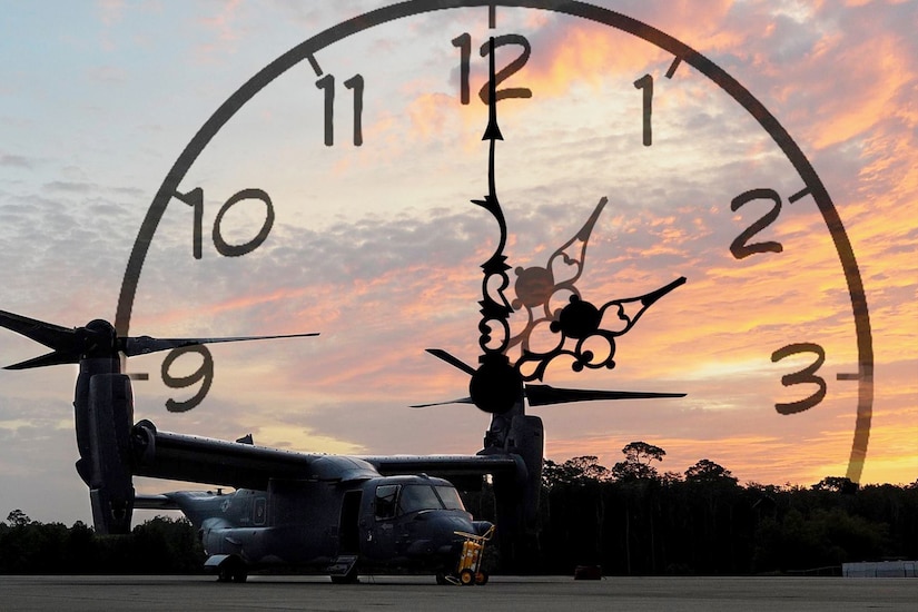 A CV-22 Osprey sits on a field at sunrise with a clock superimposed behind it.