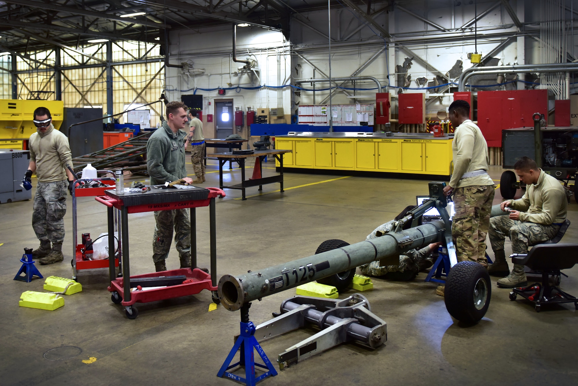 People work on various pieces of equipment.