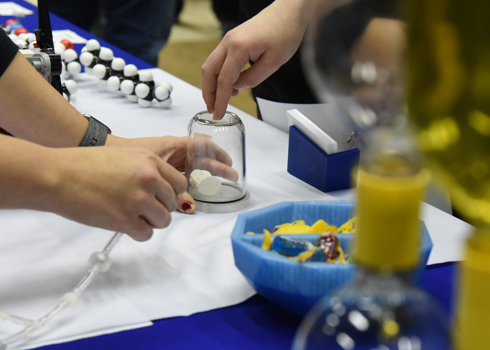 Starbase Goodfellow Air Force Base Office Manager Tiffany Ellwanger, walks through a science experiment with students from the Concho Valley and surrounding areas at the youth career fair, Careers Y’all, at the McNease Convention Center, in San Angelo, Texas, March 6, 2019.  Starbase exposed the students to a variety of educational fields such as science, technology, engineering and mathematics. (U.S. Air Force photo by Airman 1st Class Abbey Rieves/Released)