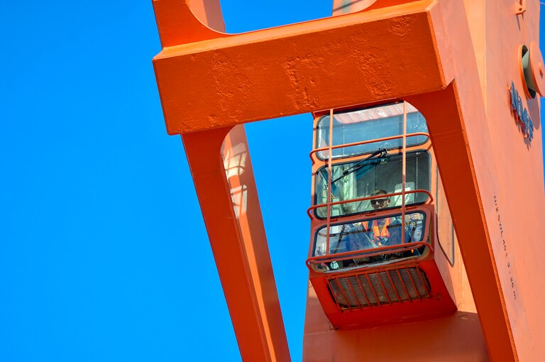 A sailor operates a crane.