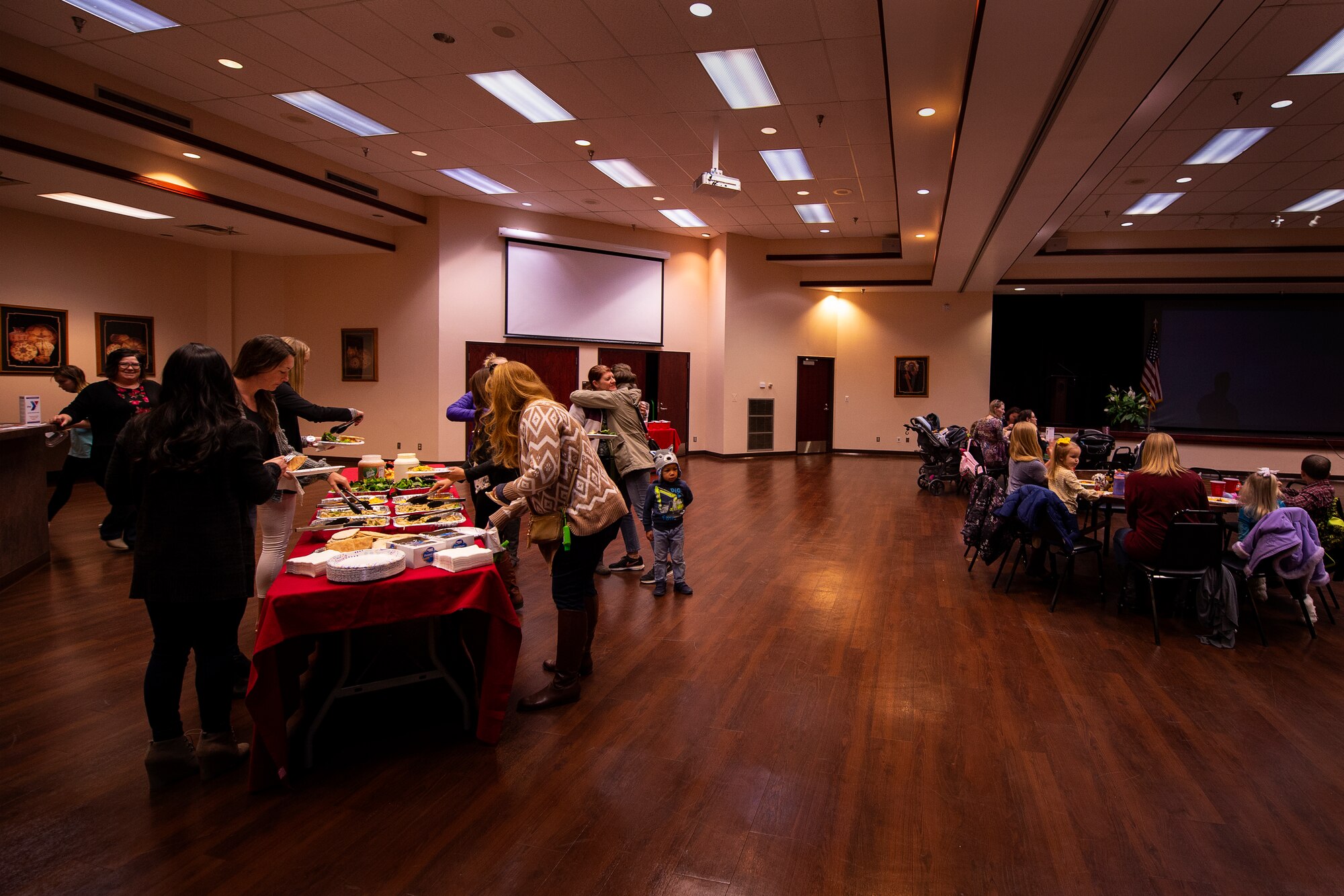 Military spouses and other base members serve themselves food during a severe weather preparation luncheon Mar. 5, 2019 at Altus Air Force Base, Okla.