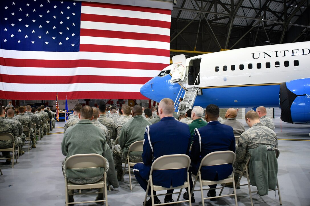 The former commander of the 932nd Airlift Wing's Maintenance Group, Col. Sharon Johnson, steps up to the podium to speak about service to country by the honoree of the day, Master Sgt. Kenna Collier.  She retired in a special ceremony among friends, family and coworkers held March 9, 2019, at Scott Air Force Base, Illinois.   Master Sergeant Kenna K, Collier and maintenance Airmen were responsible for the catering of the C-40C aircraft at right.  Collier retired from the Maintenance Group as Training Manager.  (U.S. Air Force photo by Lt. Col. Stan Paregien)
