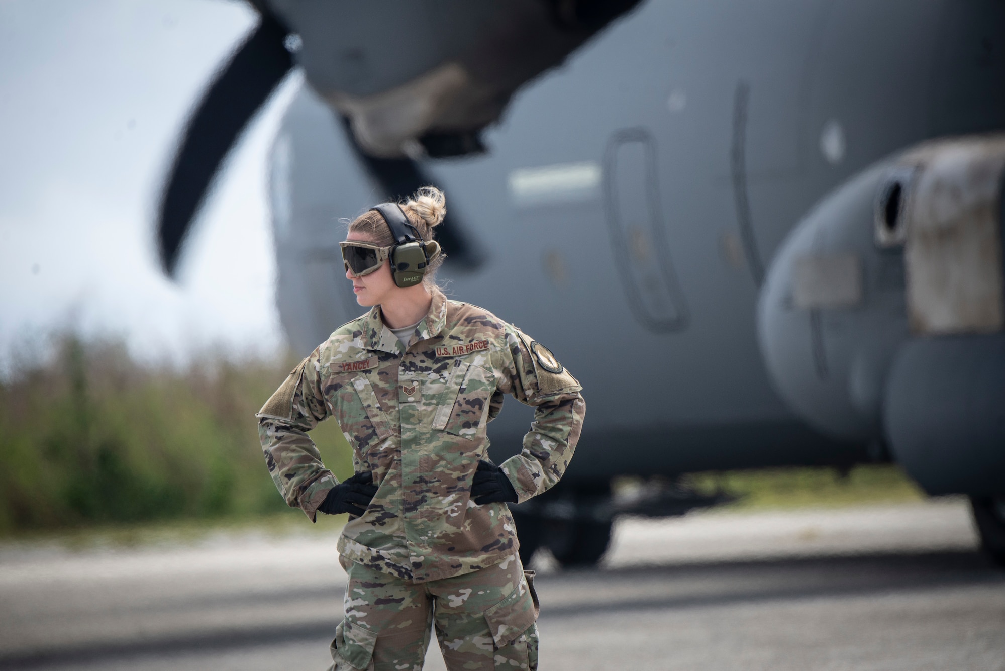 U.S. Air Force Staff Sgt. Holly Yancey, 36th Mobility Response Squadron aerial porter supervisor, from Andersen Air Force Base, Guam waits to direct passengers on the flight line during Cope North 2019 at Tinian, U.S. Commonwealth of the Northern Mariana Islands, Feb. 27, 2019.