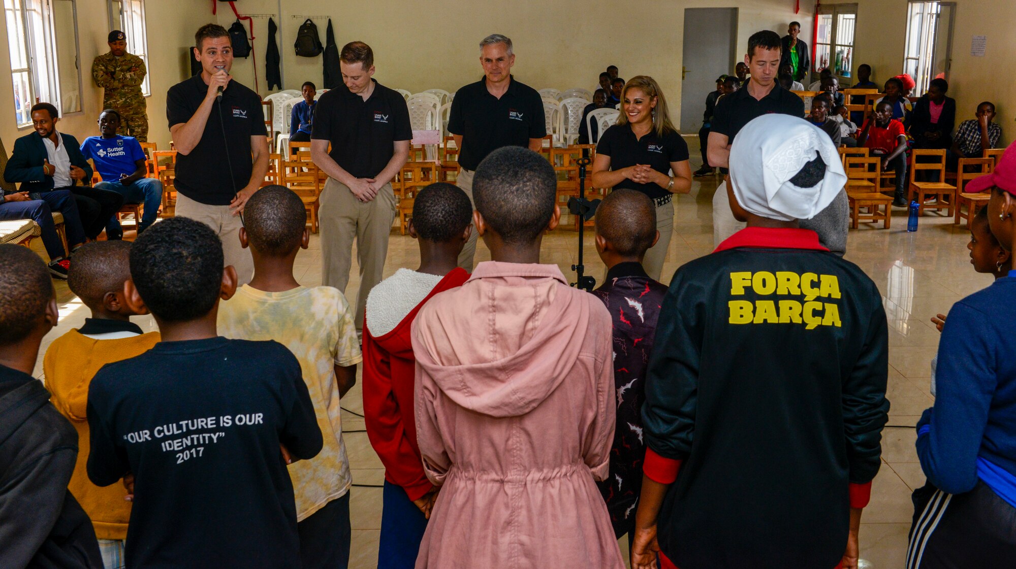 U.S. Airmen assigned to the U.S. Air Forces in Europe Band introduce themselves to the choir at the Gisimba Memorial Centre in Kigali, Rwanda, March 6, 2019. As musical ambassadors, members of the band can reach audiences that traditional military members can't. They travel the world to build cultural bridges, and honor and preserve cultural heritage. (U.S. Air Force photo by Tech. Sgt. Timothy Moore)