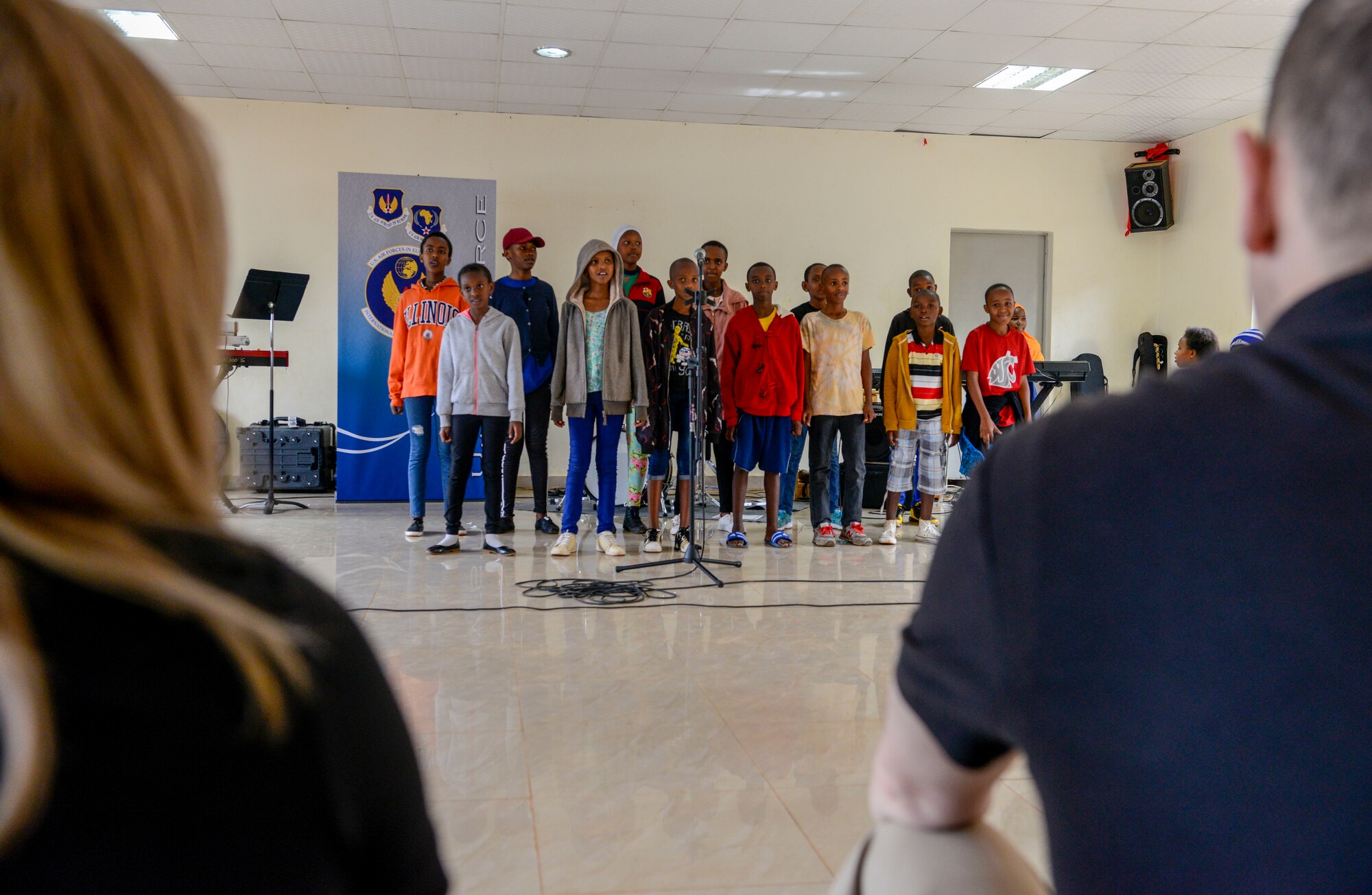 U.S. Airmen assigned to the U.S. Air Forces in Europe Band listen to a choir performance at the Gisimba Memorial Centre in Kigali, Rwanda, March 6, 2019. As musical ambassadors, members of the band can reach audiences that traditional military members can't. They travel the world to build cultural bridges, and honor and preserve cultural heritage. (U.S. Air Force photo by Tech. Sgt. Timothy Moore)