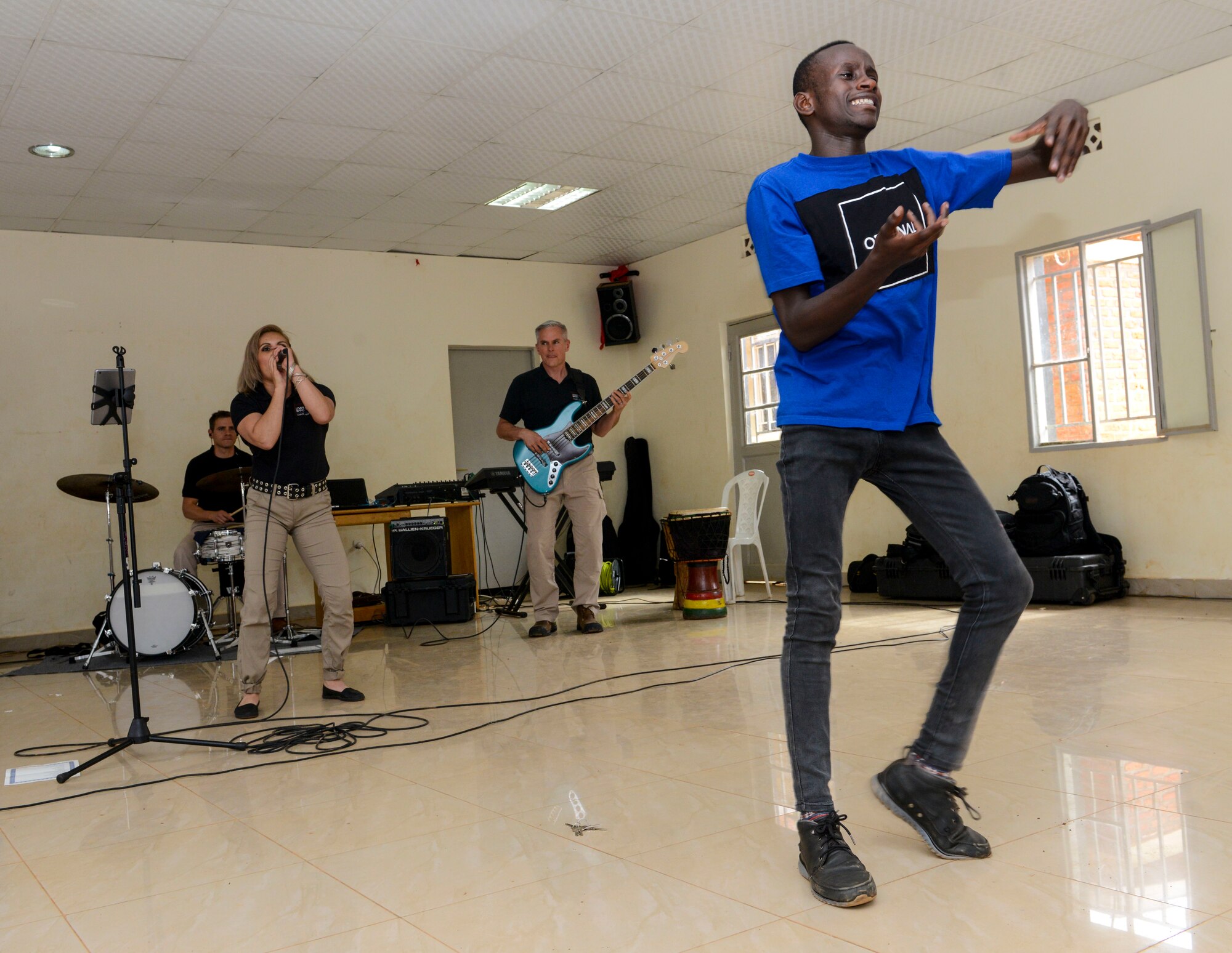 A student dances to music played by the U.S. Air Forces in Europe Band Touch N' Go during a performance at the Gisimba Memorial Centre in Kigali, Rwanda, March 6, 2019. As musical ambassadors, members of the band can reach audiences that traditional military members can't. They travel the world to build cultural bridges, and honor and preserve cultural heritage. (U.S. Air Force photo by Tech. Sgt. Timothy Moore)